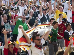 German fans celebrate near the Brandenburg Gate in Berlin during the public viewing of FIFA World Cup 2014 football match Germany vs Portugal  played in Salvador, Brazil on June 16, 2014.