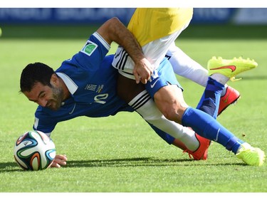 Greece's midfielder Giorgos Karagounis in action against Colombia's forward Jackson Martinez (Top) during a group C football match between Colombia and Greece at the Mineirao Arena in Belo Horizonte during the 2014 FIFA World Cup on June 14, 2014.