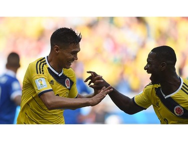 Colombia's forward Teofilo Gutierrez (L) celebrates with Colombia's defender Cristian Zapata after scoring during a Group C football match between Colombia and Greece at the Mineirao Arena in Belo Horizonte during the 2014 FIFA World Cup on June 14, 2014.