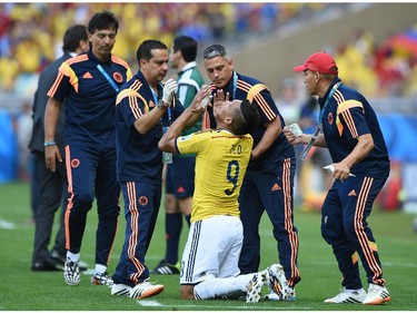 Colombia's forward Teofilo Gutierrez receives medical assistance during a Group C football match between Colombia and Greece at the Mineirao Arena in Belo Horizonte during the 2014 FIFA World Cup on June 14, 2014.