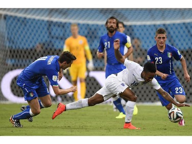 England's midfielder Raheem Sterling (C) falls to the ground as Marco Verratti (R) and Matteo Darmian (L) defend during a Group D football match between England and Italy at the Amazonia Arena in Manaus during the 2014 FIFA World Cup on June 14, 2014.