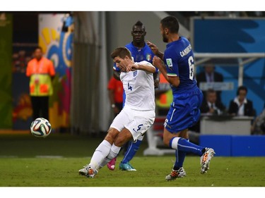 England's midfielder and captain Steven Gerrard (L) and Italy's midfielder Antonio Candreva (R) vie for the ball during a Group D football match between England and Italy at the Amazonia Arena in Manaus during the 2014 FIFA World Cup on June 14, 2014.