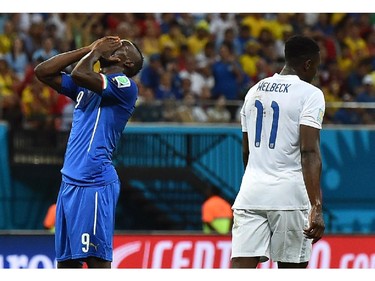 Italy's forward Mario Balotelli (L) reacts during a Group D football match between England and Italy at the Amazonia Arena in Manaus during the 2014 FIFA World Cup on June 14, 2014.