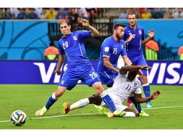 Italy's defender Gabriel Paletta (L), Italy's defender Andrea Barzagli (C-top) and Italy's defender Giorgio Chiellini (R) defend as England's forward Daniel Welbeck tries to score during a Group D football match between England and Italy at the Amazonia Arena in Manaus during the 2014 FIFA World Cup on June 14, 2014.