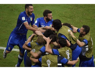 Italy's national football team players celebrate after scoring during a Group D football match between England and Italy at the Amazonia Arena in Manaus during the 2014 FIFA World Cup on June 14, 2014.