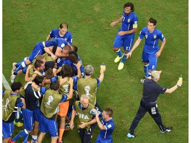 Italy's national football team players celebrate after scoring during a Group D football match between England and Italy at the Amazonia Arena in Manaus during the 2014 FIFA World Cup on June 14, 2014.       POOL