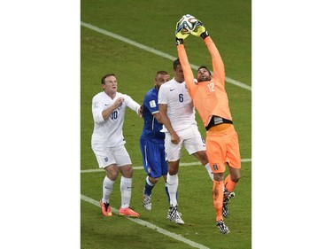 Italy's goalkeeper Salvatore Sirigu (R) grabs the ball during a Group D football match between England and Italy at the Amazonia Arena in Manaus during the 2014 FIFA World Cup on June 14, 2014.