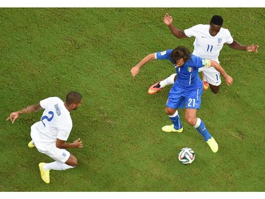 England's defender Glen Johnson (L) and England's forward Daniel Welbeck (R) challenge Italy's midfielder Andrea Pirlo for the ball during a Group D football match between England and Italy at the Amazonia Arena in Manaus during the 2014 FIFA World Cup on June 14, 2014.