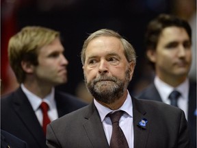Federal NDP Leader Tom Mulcair waits for the start of the RCMP regimental funeral on Tuesday, June 10, 2014 in Moncton, N.B. for the three RCMP officers who were gunned down in Moncton last week.