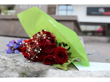 Flowers and candles are seen in front of Les Suites hotel on Besserer Street where Brandon Volpi was stabbed to death early Saturday morning, on Sunday, June 8, 2014.