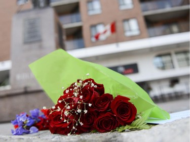 Flowers and candles are seen in front of Les Suites hotel on Besserer Street where Brandon Volpi was stabbed to death early Saturday morning, on Sunday, June 8, 2014.