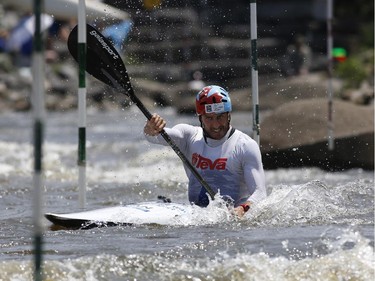 Former Canadian National Team paddler John Hastings competes in the Kayak (K1) Men's category at the first Ontario canoe slalom race of the year, at the Pumphouse downtown Ottawa on June 29, 2014. Many of these paddlers have hopes of representing Ontario at the PanAm games in 2015, while others are local recreational paddlers racing for the first time.