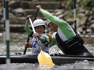 Former Olympian C2 athlete Larry Norman takes a fun run with his son Cole at the first Ontario canoe slalom race of the year, at the Pumphouse downtown Ottawa on June 29, 2014. Many of these paddlers have hopes of representing Ontario at the PanAm games in 2015, while others are local recreational paddlers racing for the first time.