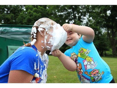 Four-year-old Bella Yenson is all smiles after administering a shaving-cream pie to the face of a volunteer at the CHEO Teddy Bear pinic at Rideau Hall on Saturday.