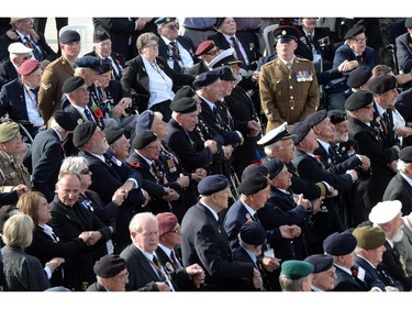 WWII veterans hold hands as they attend a D-Day commemoration ceremony for veterans in Arromanches-les-Bains, Normandy, on June 6, 2014, marking the 70th anniversary of the World War II Allied landings in Normandy.