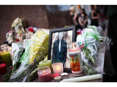 Friends of slain teen Brandon Volpi swap stories and mourn their classmate, friend, and family member at a vigil out front of Les Suites in Ottawa on Sunday, June 8, 2014.