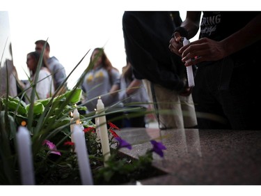 Friends of murdered teen Brandon Volpi swap stories and mourn their classmate, friend, and family member at a vigil out front of Les Suites in Ottawa on Sunday, June 8, 2014.