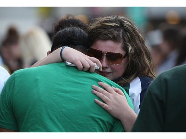 Friends of murdered teen Brandon Volpi swap stories and mourn their classmate, friend, and family member at a vigil out front of Les Suites in Ottawa on Sunday, June 8, 2014.