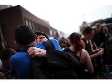 Friends of murdered teen Brandon Volpi swap stories and mourn their classmate, friend, and family member at a vigil out front of Les Suites in Ottawa on Sunday, June 8, 2014.