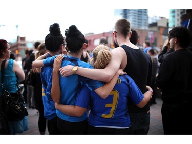 Friends of murdered teen Brandon Volpi swap stories and mourn their classmate, friend, and family member at a vigil out front of Les Suites in Ottawa on Sunday, June 8, 2014.