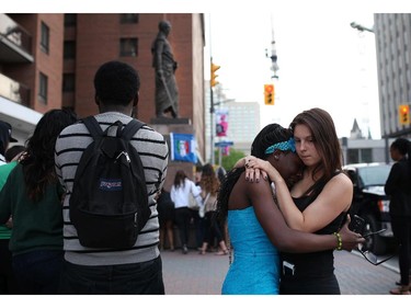 Friends of murdered teen Brandon Volpi swap stories and mourn their classmate, friend, and family member at a vigil out front of Les Suites in Ottawa on Sunday, June 8, 2014.