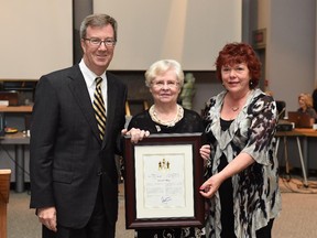 Doreen Lebano (centre) receives the Mayor's City Builder Award from Mayor Jim Watson and Coun. Jan Harder.