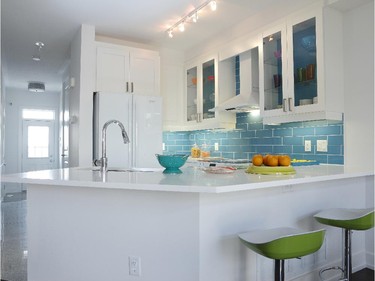 The Adirondack, the smallest of Glenview Homes' townhome models at Monahan Landing, sings with bright colours, starting with teal blue tiles in the upgraded kitchen.