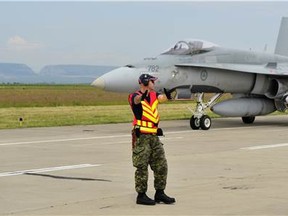 Corporal Dan Van Haaren marshalls in a CF-18 Hornet on 5 June 2014 in CâmpiaTurzii, Romania where members of Canadian Air Task Force are participating in NATO Reassurance Measures.

Photo: LS Alex Roy, 3 Wing Imaging
BN2014-1018-04