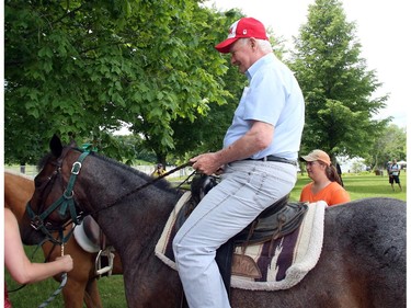 Governor General David Johnston takes a short ride on a pony as he attends a powwow at the Summer Solstice Aboriginal Arts Festival in Ottawa, Saturday June 21, 2014. THE CANADIAN PRESS/Fred Chartrand