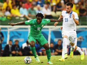 Wilfried Bony of the Ivory Coast controls the ball against Andreas Samaris of Greece during the 2014 FIFA World Cup Brazil Group C match between Greece and the Ivory Coast at Castelao on June 24, 2014 in Brazil.