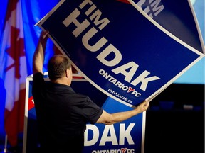 An Ontario PC organizer prepares signage for the headquarters of Tim Hudak at the Mountain Ridge Community Centre in Grimsby Ontario prior to election evening results, Thursday June 12, 2014.