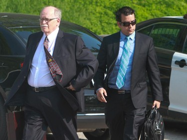 Election Canada investigator Allan Mathews, left and Chris Crawford, right, Conservative staffer and witness for the prosecution arrive at the courthouse in Guelph Ontario for the first day of the Robocall trial on June 2, 2014. The trial will focus on allegations that defendant Michael Sona was responsible for robocalls or real-person calls made to voters (mostly in the riding of Guelph, Ontario) to dissuade voters from casting ballots in the May, 2011 federal election, by telling them the their polling station location had been changed.