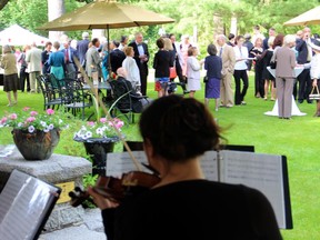 Guests mingled while a trio of classical musicians performed during the F�te Champ�tre garden party for the Ottawa Symphony Orchestra, held Thursday, June 5, 2014, at the Japanese ambassador's official residence.