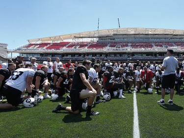 Head Coach Rick Campbell talks to the players after practice. The Ottawa Redblacks held their first practice ever at the new TD Place stadium at Lansdowne Park Friday, June 27, 2014.