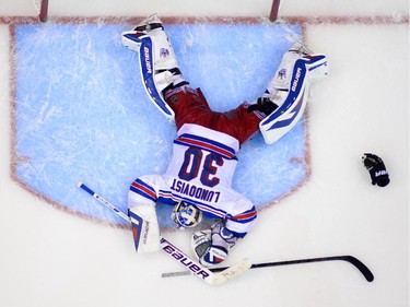 New York Rangers goalie Henrik Lundqvist, of Sweden, lays on the ice after being scored on by Los Angeles Kings defenseman Alec Martinez during the second overtime period in Game 5 of an NHL hockey Stanley Cup finals, Friday, June 13, 2014, in Los Angeles.