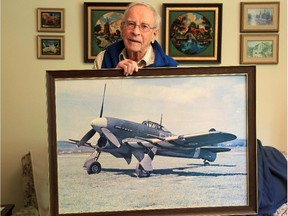 In his Cornwall living room, former Flying Officer Doug Gordon holds a picture of the Hawker Typhoon he flew on D-Day.