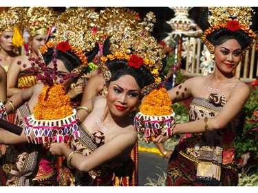 Indonesian dancers in traditional outfit perform during a parade to mark the Bali Arts Festival in Bali, Indonesia, Friday, June 13, 2014. Performances are scheduled daily during a month-long annual festival held from June 13 to July 12.