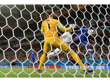 Italy's Mario Balotelli, right, scores his side's 2nd goal during the group D World Cup soccer match between England and Italy at the Arena da Amazonia in Manaus, Brazil, Saturday, June 14, 2014.