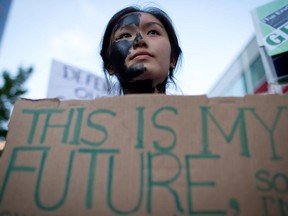 Jacqueline Lee-Tam wears face paint to simulate oil while attending a rally held to show opposition to the Enbridge Northern Gateway pipeline in Vancouver, B.C., on Tuesday June 17, 2014.