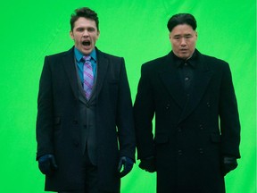 In this Nov. 29, 2013 file photo, actor James Franco, left, yawns before filming a scene with an actor playing North Korean leader Kim Jong Un for the movie "The Interview," at Robson Square in Vancouver, British Columbia. The square has been transformed into a North Korean set complete with North Korea statues and soldiers. North Korea is declaring that the upcoming release of the comedy film, which features a plot to assassinate Kim Jong Un, would be an act of war. (AP Photo/The Canadian Press, Darryl Dyck, File)