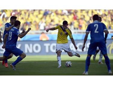 Colombia's James Rodriguez (10) kicks the ball to score his side's third goal during the group C World Cup soccer match between Colombia and Greece at the Mineirao Stadium in Belo Horizonte, Brazil, Saturday, June 14, 2014. Colombia defeated Greece 3-0.