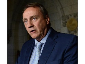 Cabinet minister John Duncan, member of the Board of Internal Economy, answers questions after delivering a statement on Parliament Hill in Ottawa on Tuesday, June 3, 2014.