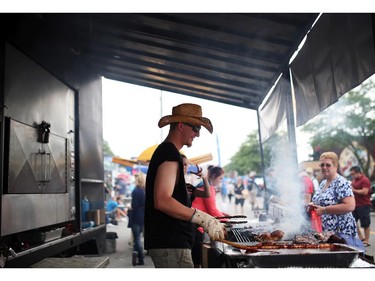 Jon Harding of Railroad Ribs cooks up ribs  in Westboro in Ottawa, during Westfest on Saturday, June 14, 2014.