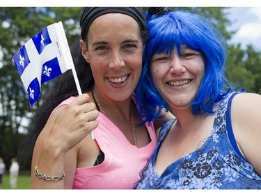 Josee Grieken and Chantal Cardona wave Quebec's flag at Saturday's Festival de la St-Jean, at Centre Richelieu in Vanier.