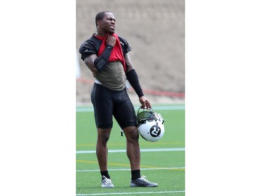 Jovon Johnson #2, of the Ottawa Redblacks wipes his face on a hot day during a practice at TD Place stadium in Ottawa on June 29, 2014.