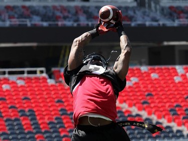 Jovon Johnson catches the ball high in the air during practice. The Ottawa Redblacks held their first practice ever at the new TD Place stadium at Lansdowne Park Friday, June 27, 2014.