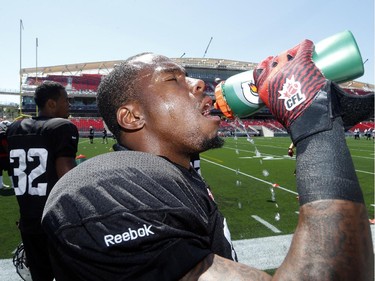 Jovon Johnson (DB) chugs back some water during the long, hot practice. The Ottawa Redblacks held their first practice ever at the new TD Place stadium at Lansdowne Park Friday, June 27, 2014.