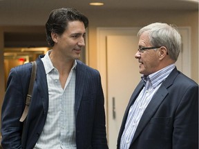 Liberal leader Justin Trudeau chats with Cardigan MP Lawrence MacAulay, right, as they attend the party's caucus retreat in Georgetown, P.E.I. on Thursday, Aug. 29, 2013.