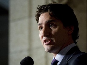 Liberal leader Justin Trudeau speaks with the media in the foyer of the House of Commons following caucus on Parliament Hill Wednesday.