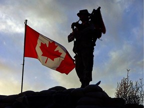 Kabul, Afghanistan. 1 November 2005- As the sun sets Corporal (Cpl) Michael Meagher pipes down the Canadian Flag that is flying over a Forward Operating Base somewhere in Afghanistan.